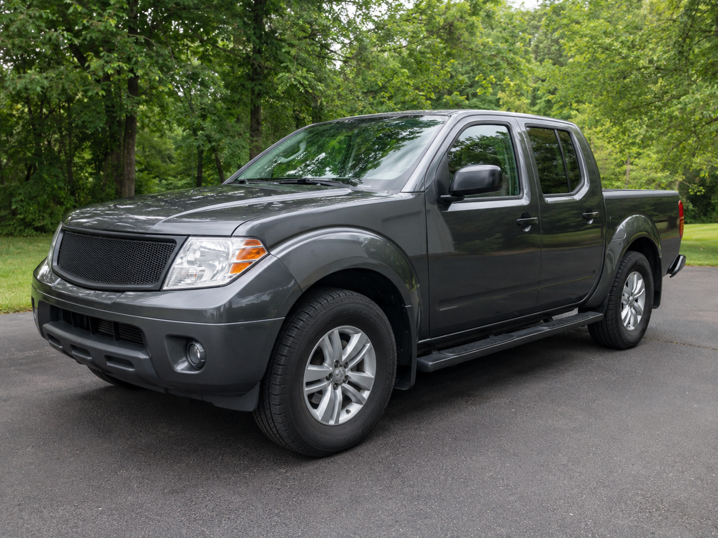 Dark gray midsize pickup truck shown from the front three-quarter angle